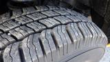 Close-up of a worn tire from a 2015 Ford Econoline showing the tread pattern and wear indicators