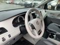 Interior view of a 2013 Toyota Sienna showing the steering wheel dashboard and control panel