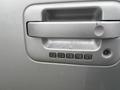 Close-up of a silver 2014 Ford F-150 door handle featuring a keypad entry system with numbered buttons for access