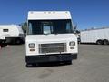 Front view of a white 2007 Ford Econoline with a large windshield and horizontal grille featuring multiple headlights