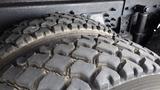 Close-up of a large rugged tire from a 2008 International 7500 showcasing deep treads designed for off-road traction