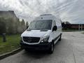 A white 2016 Mercedes-Benz Sprinter van is parked with its front facing the viewer showcasing its signature grille and logo