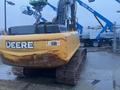 2014 John Deere 350G excavator with a yellow body and large rubber tracks visible from the rear angle