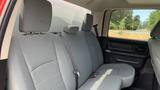 The interior of a 2013 RAM 2500 featuring gray cloth seats with a bench design and seat belts