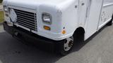 A 2011 Ford Econoline delivery van with a white exterior and worn features, showing a slightly damaged front grille and one visible tire