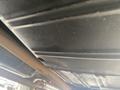 Underside view of a 1966 Ford Mustang showing the metal chassis and exhaust system components