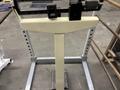 Gym equipment set featuring a weight scale with a large flat base and a weight measurement bar at the top