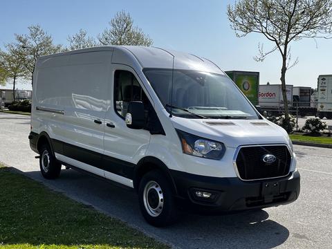 A 2022 Ford Transit van with a white exterior and black accents parked at an angle showing the front and side views