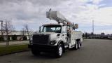 A 2008 International 7500 utility truck with a white and gray color scheme featuring an elevated hydraulic boom mounted on the chassis