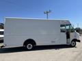 A white 2012 Ford Econoline box truck with no markings on its side and a single door open on the driver's side