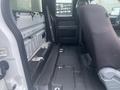 2013 Ford F-150 interior showing an empty cab with a single seat installed and exposed metal surfaces along the sides and floor