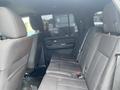 Interior view of the backseat of a 2017 Ford Expedition with dark fabric seats and seatbelts visible