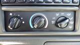 Control panel with knobs for climate and air conditioning settings in a 2006 Ford F-650