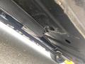 A 1966 Ford Mustang viewed from underneath showing the underside of the chassis with metal components and exhaust pipes visible