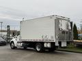 A 2017 Kenworth T370 truck with a large white cargo box and rear doors, parked and showing its distinctive cab and chassis design