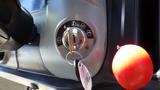 Close-up of the ignition switch and key of a 2013 Kubota RTV 1100 with a bright red lever prominently displayed