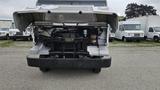 A 2006 Ford Econoline with its hood raised revealing the engine compartment