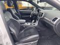 Interior view of a 2018 Jeep Grand Cherokee showing front seats and dashboard features with leather and suede upholstery