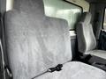 Two grey fabric truck seats in a 2006 Hino 268 with seat belts visible