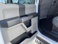 A close-up of the door panel of a 2019 Ford F-350 SD featuring a textured black handle and gray interior design elements