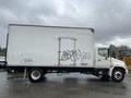 A 2008 Hino Conventional Cab truck with a white box cargo area featuring graffiti on one side and an air-ride equipped sticker near the rear