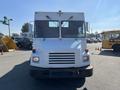 2010 Freightliner MT45 Garbage Truck with a white cab and front grille featuring multiple headlights