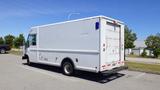 A white 2006 Ford Econoline cargo van parked with a boxy shape and large rear door for loading cargo