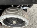 Close-up of a large wheel with a metal hub and rubber tire designed for a JLG R1932 aerial lift equipment