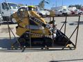 A yellow 2024 AGT KTT23 Mini Skid Steer with a bucket attachment and tracks displayed within a metal frame