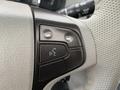 Close-up of the steering wheel controls in a 2013 Toyota Sienna featuring buttons for phone and voice commands