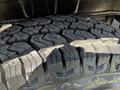 Close-up of a rugged tire tread designed for off-road driving showcasing deep grooves and patterns for traction