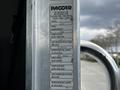 A 2014 Kenworth T370 truck door with a visible vehicle information label detailing tire specifications and dimensions