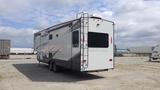 A 2021 Forest River Cedar Creek travel trailer with a sleek design featuring large windows and a ladder on the back for roof access