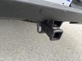 A close-up view of the hitch receiver of a 2013 Chevrolet Silverado Hybrid showing its rectangular shape and mounting points