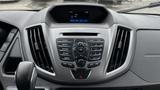 Dashboard of a 2017 Ford Transit featuring a central control panel with buttons for radio media sound and a digital display showing time and date