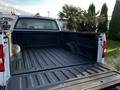 A 2008 Ford F-150 XL with an open truck bed featuring a textured black liner and smooth cargo area