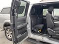 Interior of a 2014 Ford F-150 showing the rear seats with the passenger door open and a rubber floor mat visible