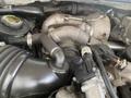 Close-up view of the engine components of a 2010 Ford F-550 showing the turbocharger hoses and various mechanical parts