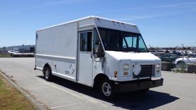 A white 2006 Ford Econoline truck with a boxy design and no visible company branding parked on a paved surface