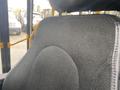 Black fabric-covered seat from a 2017 Chevrolet Express with visible stitching and contours