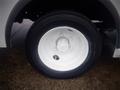 Close-up of a white wheel on a 2003 Freightliner MT45 Chassis featuring a black tire and multi-bolt pattern on the rim