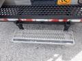 A metal step with a textured surface mounted on a black frame designed for access to the 2007 Morgan Olson Workhorse W42 vehicle