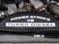 A close-up of an engine cover for a 2009 Ford F-450 SD featuring the text Power Stroke V8 Turbo Diesel