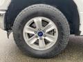 A close-up view of the wheel and tire of a 2017 Ford F-150 showcasing the silver alloy rim and all-terrain tire with the Ford logo visible on the center cap