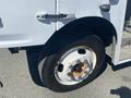 Close-up of a 2007 Freightliner MT55 wheel showing a white rim with rust spots and a black tire with visible tread patterns