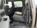 Interior view of a 2013 Chevrolet Silverado Hybrid showing the rear seating area with dark fabric upholstery and a console on the side