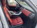 Interior view of a 2020 Land Rover Range Rover Sport featuring red leather seats and modern dashboard design