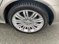 Close-up of a silver alloy wheel with a Mercedes-Benz emblem and a Michelin tire showcasing its detailed design and tread pattern