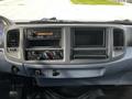 Dashboard of a 2006 Hino 268 showing radio controls air conditioning knobs and empty slots for additional equipment