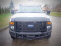 A front view of a white 2008 Ford F-550 with a black grille and orange headlights